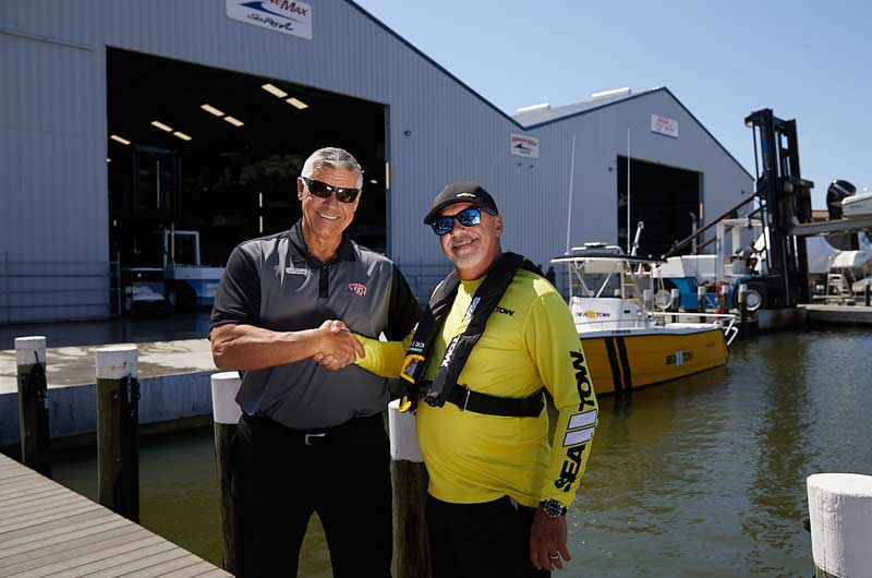 marine max shakes hands with sea tow franchise owner